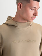Alpinestars Datrix Hoodie, Sportswear Pullover Hoodie, Unisex, Putty Brown, featuring tonal HD Alpinestars branding, mesh-lined hood, and tri-blend double-face fleece construction, close-up view on model.