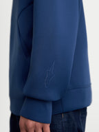 Alpinestars Datrix Hoodie, Premium Sportswear Pullover, Steel Blue, close-up view of the sleeve featuring a tonal HD Alpinestars logo, made from tri-blend double-face fleece fabric for casual everyday wear.