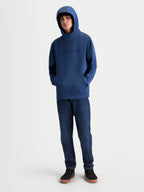 Alpinestars Datrix Hoodie, Motorsport-Inspired Sportswear Pullover, Steel Blue, Premium Tri-blend Fleece, featuring a tonal HD logo on the chest and a mesh-lined hood worn up by a model.