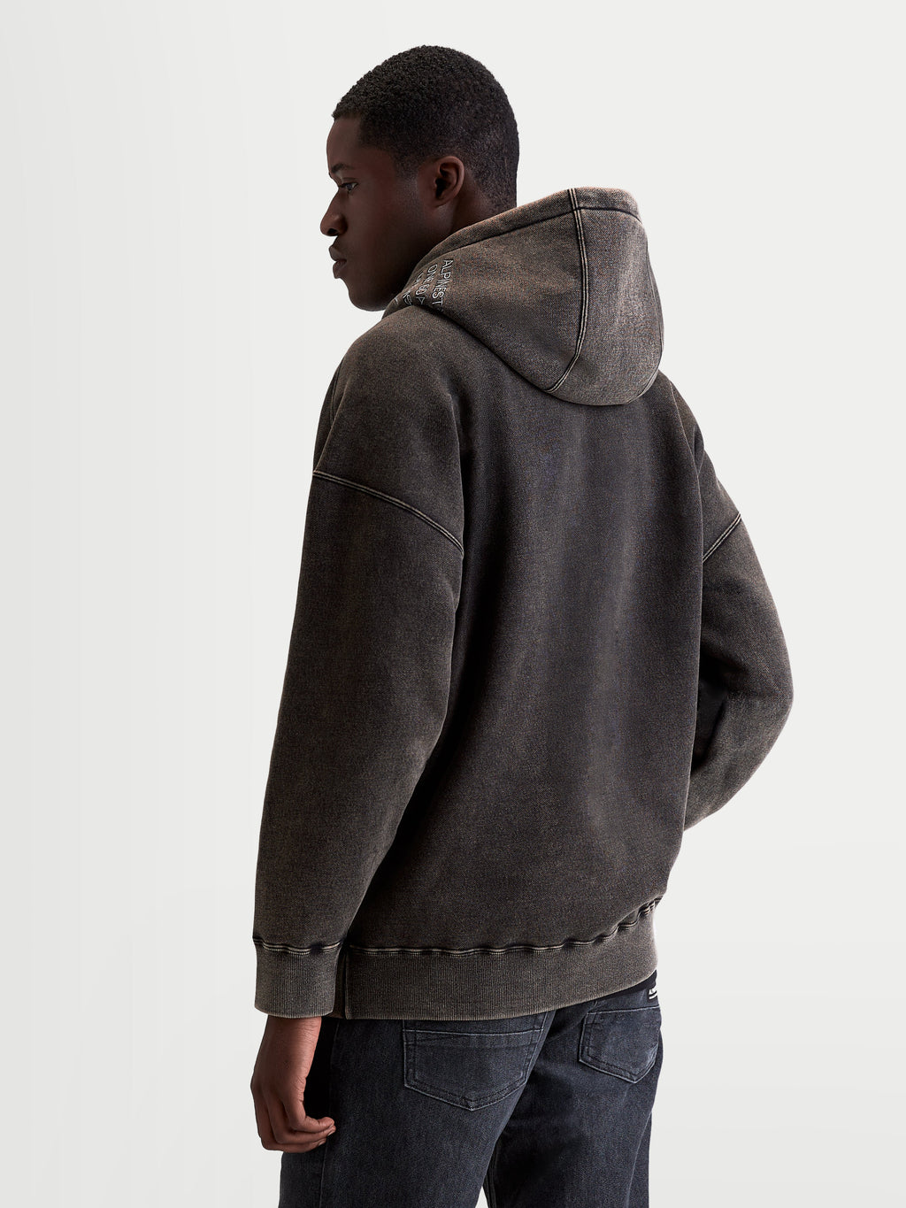 Alpinestars Infinite Washed Oversized Hoodie, Men's Sportswear Pullover in Washed Black, Snow-Wash Finish Fleece, relaxed fit with self-lined hood and embroidered logo detailing, back view on model.