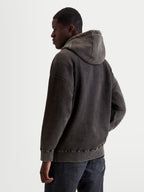Alpinestars Infinite Washed Oversized Hoodie, Men's Sportswear Pullover in Washed Black, Snow-Wash Finish Fleece, relaxed fit with self-lined hood and embroidered logo detailing, back view on model.