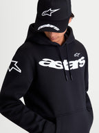 Alpinestars Velocifier Hoodie, Black Sportswear Pullover Fleece, on-model view showcasing the white curved Astars wordmark on the chest and star logo on the shoulder. This premium casual hoodie features a drawstring hood and kangaroo pocket, ideal for off-bike motorsports style.