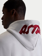 Alpinestars Pioneer Oversized Hoodie, Casual Sportswear Fleece for Men and Women, Cement Gray with Red embroidered logo on the hood, on-model back view highlighting the oversized fit and premium branding.