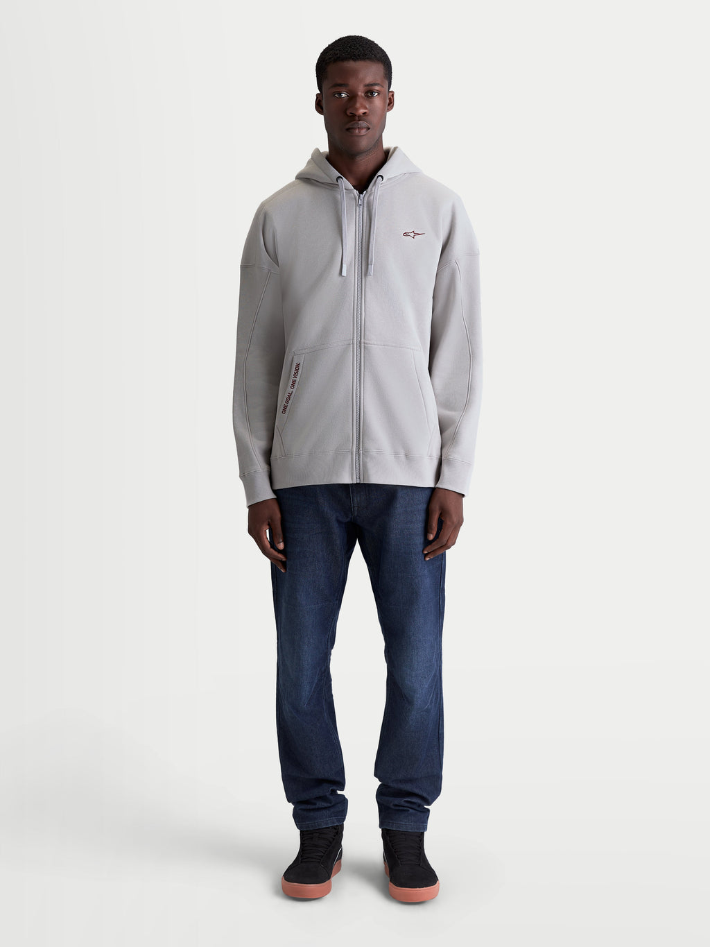 Alpinestars Pioneer Oversized Hoodie, Sportswear Lifestyle Zip-Up Fleece, Cement Grey, Relaxed Oversized Fit with Vislon Zipper and Kangaroo Pocket, Embroidered One Goal One Vision Branding, Full-Length Front View on Model