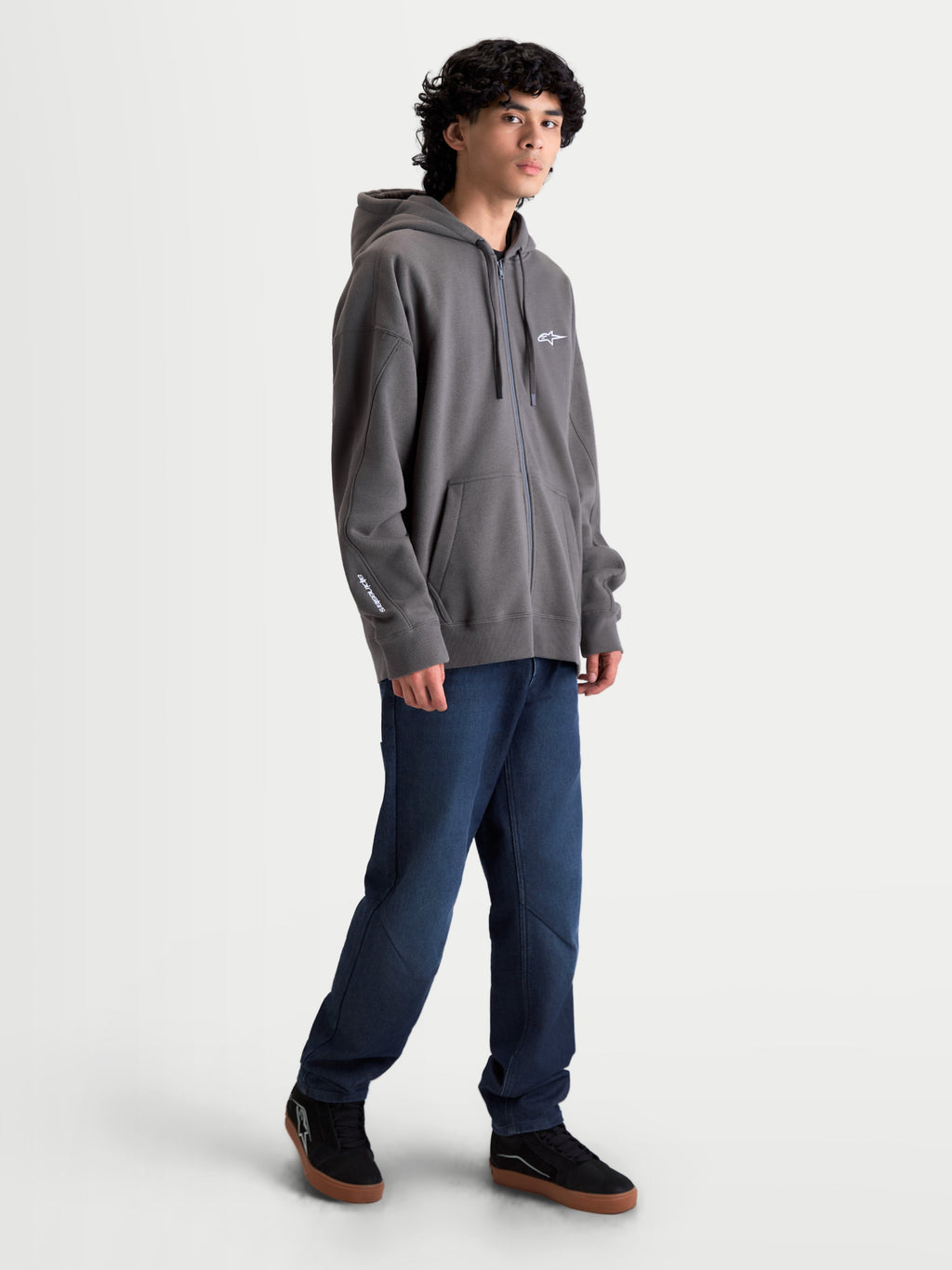 Alpinestars Entity Oversized Hoodie, Sportswear Zip-Up Fleece, Charcoal Gray, featuring an oversized fit, Vislon front zipper, kangaroo pockets, and white embroidered Alpinestars branding on the chest and sleeve. Casual motorsport-inspired lifestyle apparel.