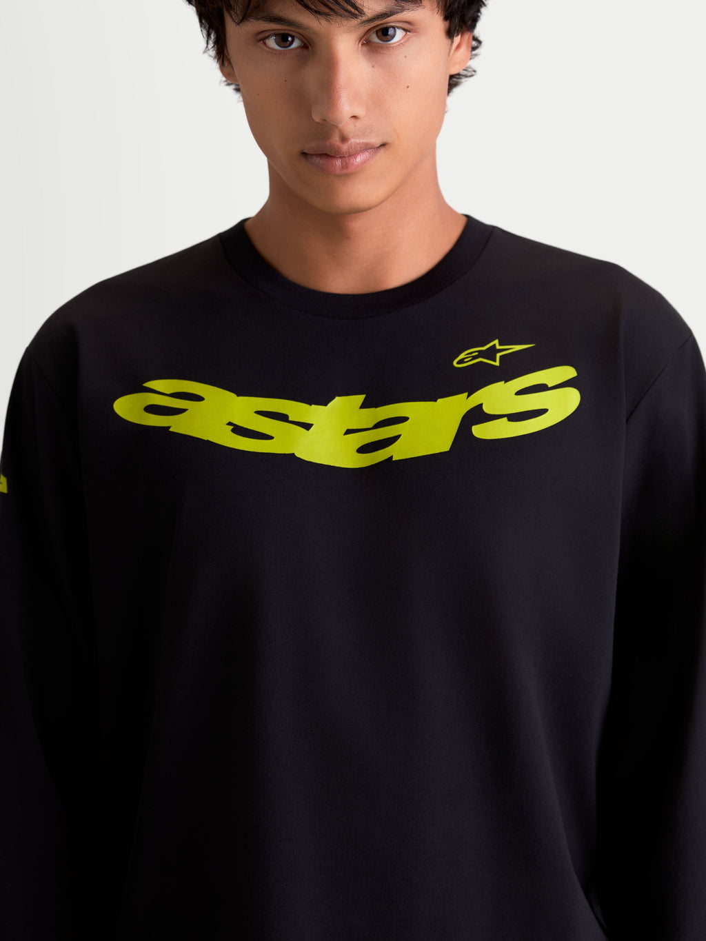 Alpinestars Velocifier CSF Tee, Long Sleeve Casual Sportswear on model, Black with Yellow curved astars chest graphic and shoulder logo, cotton-rich performance blend.