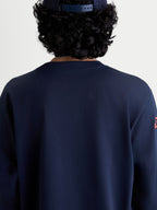Alpinestars Velocifier CSF Tee, Long Sleeve Sportswear T-Shirt in Navy Blue, back view on model featuring a ribbed crew neck, motorsport-inspired casual apparel made from a soft cotton and recycled polyester blend.