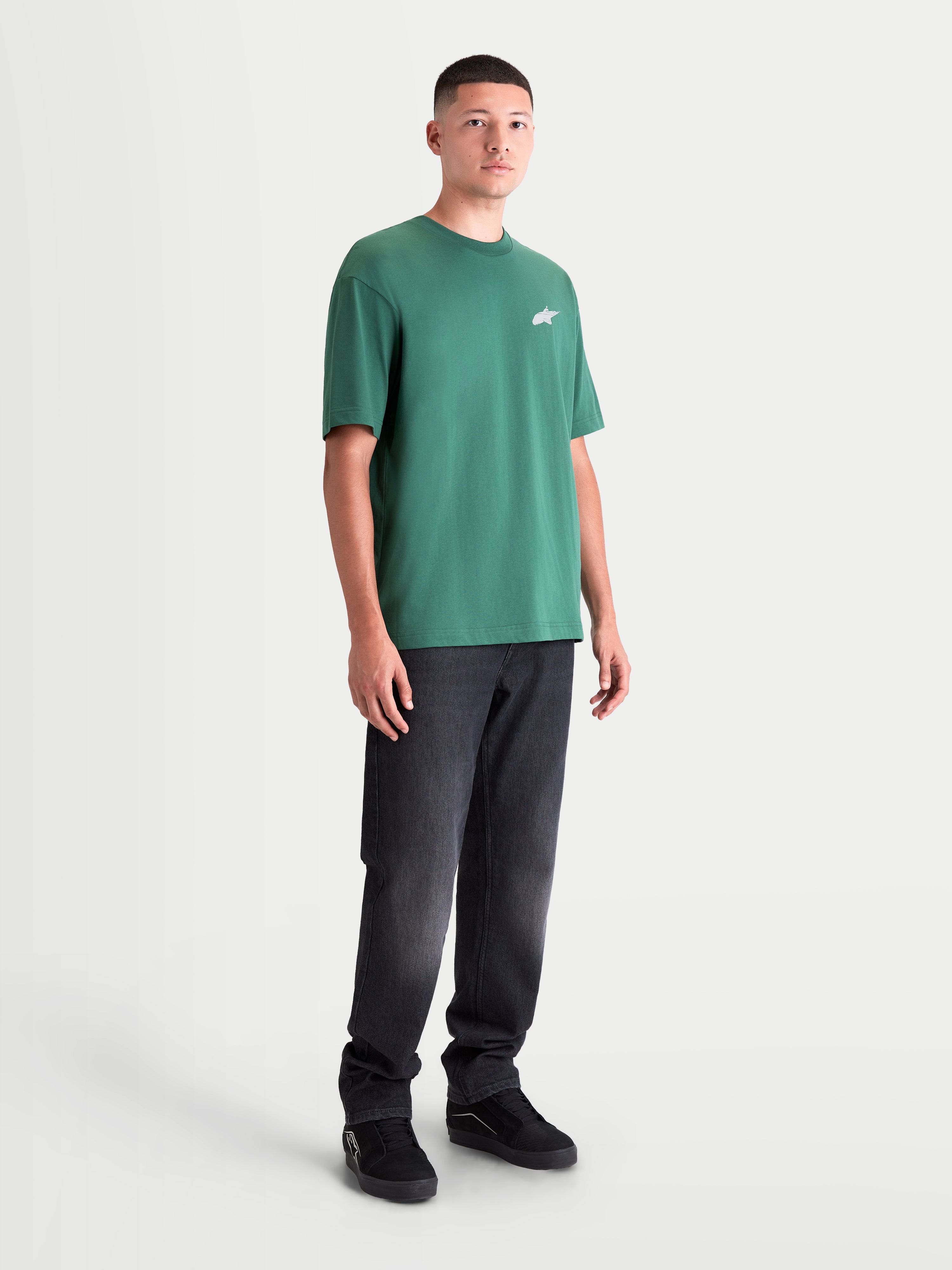 Alpinestars Checkback Oversized CSF Tee, Green Short Sleeve Sportswear T-Shirt for Men and Women, featuring a small white Astars logo on the chest and a relaxed oversized fit, front view on model.
