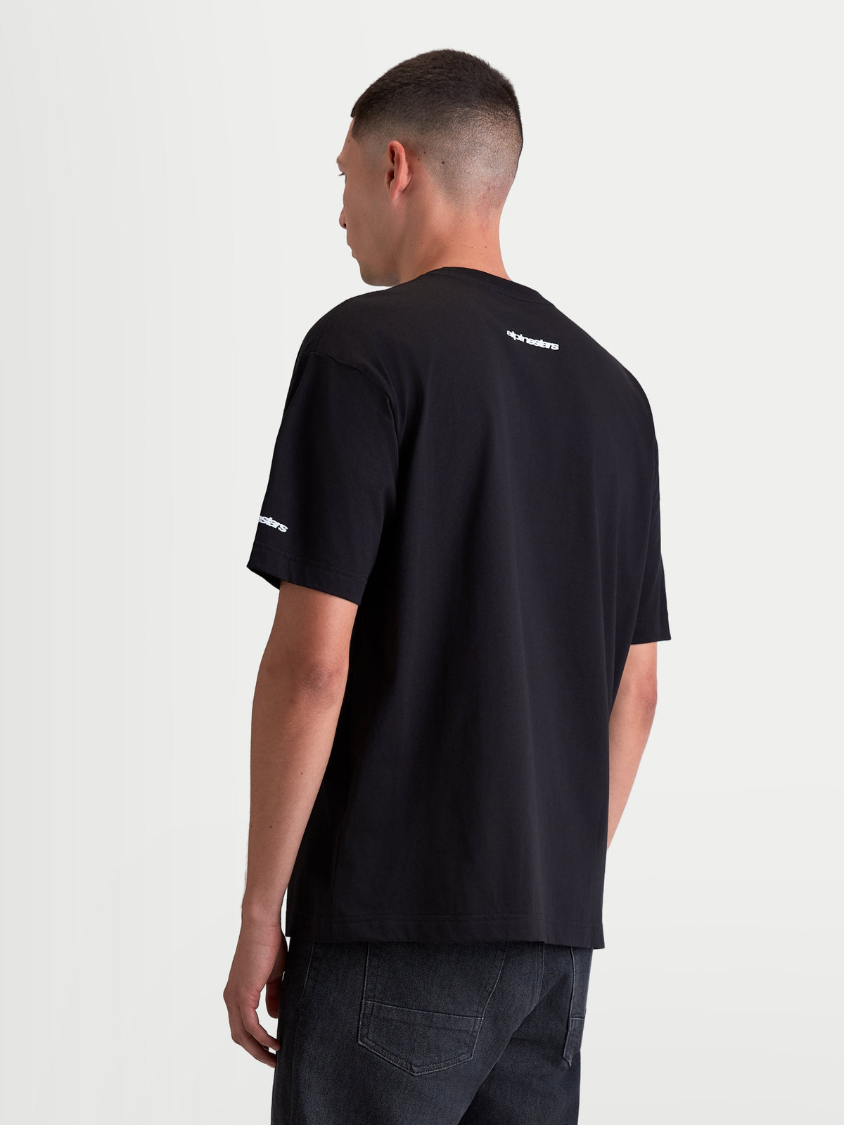 Alpinestars Mandate Oversized CSF Tee, Men's Black Short Sleeve Sportswear T-Shirt, Rear View featuring white wordmark logos on the back neck and sleeve, Relaxed Oversized Fit for casual comfort.