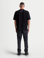 Alpinestars Prelude Oversized CSF Tee, Men's and Women's Short Sleeve Sportswear T-Shirt in Black, featuring a rear Alpinestars word logo graphic on the upper back, on-model back view, soft cotton-poly blend lifestyle clothing.