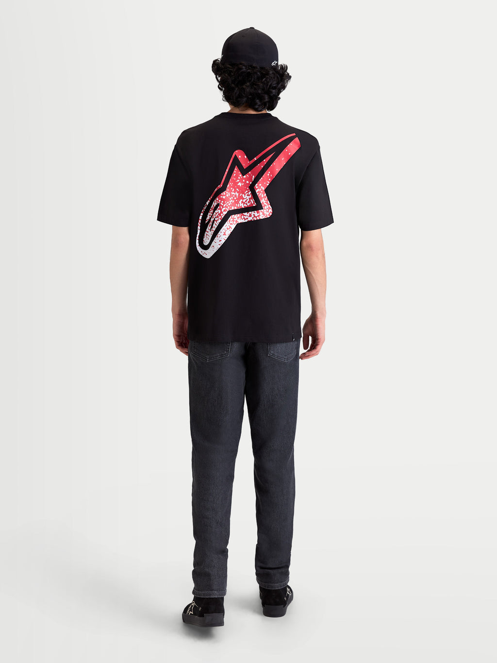 Alpinestars Meteor CSF Tee, Short Sleeve Sportswear T-Shirt, Black, Red, and White. On-model rear view featuring a large back Astars logo with an MX-inspired red and white gradient graphic.