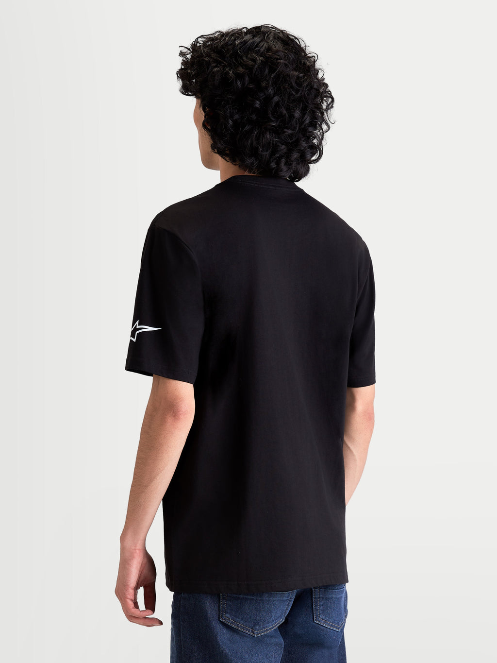 Alpinestars Race Wordmark CSF Tee, Casual Sportswear Short Sleeve T-Shirt, Black with White Ageless Logo on the Sleeve, Back View on Model, Motorsport Inspired Apparel