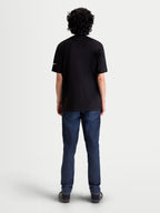 Alpinestars Race Wordmark CSF Tee, Black Short Sleeve Sportswear T-Shirt, back view on model, featuring a white Ageless logo on the sleeve. Casual motorsport-inspired apparel made from a soft cotton-poly blend.