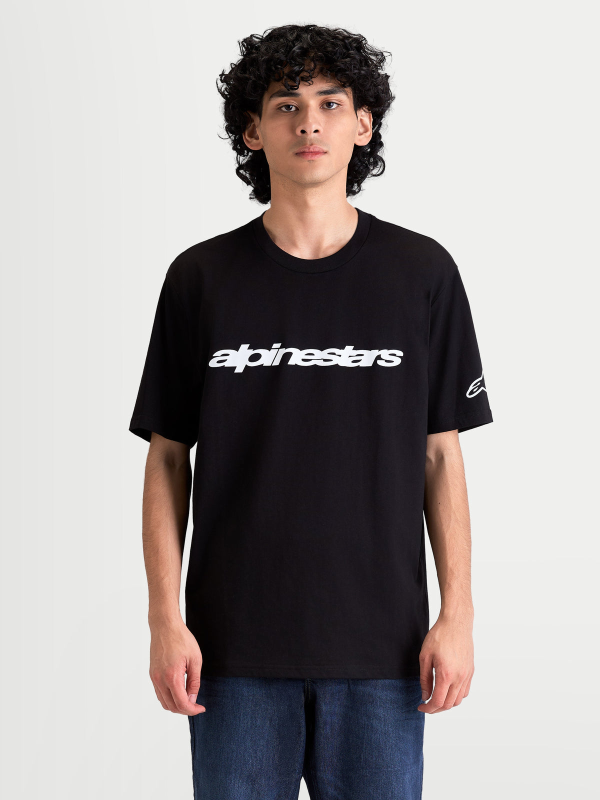 Alpinestars Race Wordmark CSF Tee, Men's Casual Sportswear Short Sleeve T-shirt on model, Black and White, featuring a bold front logo graphic and sleeve Ageless logo.