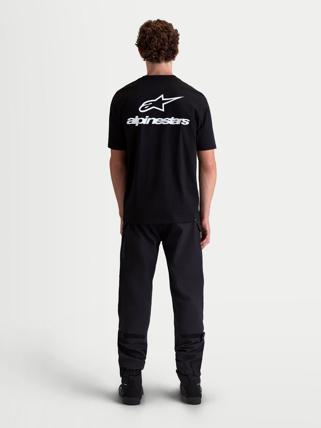Alpinestars Combo Back CSF Tee, Short Sleeve Sportswear T-Shirt, Black and White, featuring a large white Astars logo and text graphic on the back, premium cotton-poly blend for casual motorsport-inspired style, back view on model.