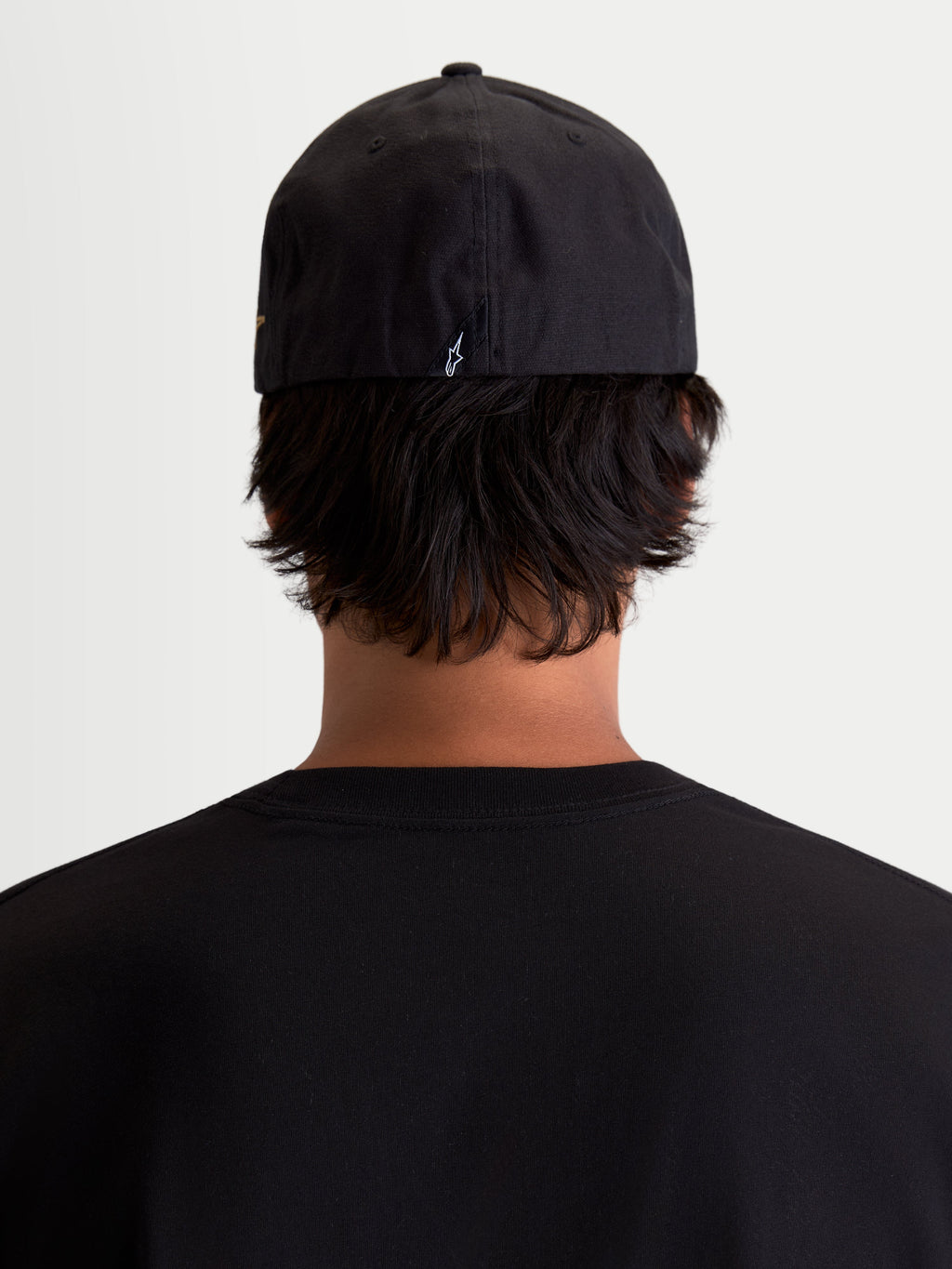 Alpinestars County Canvas Hat, Black Sportswear Cap, Rear View on Model, featuring Flex-back fit and small embroidered Astars logo on the back, Oxford peached canvas material for everyday comfort.