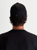 Alpinestars Arclight Hat, Black Sportswear Baseball Cap, Rear View on Model, Featuring a Small White Astars Logo on the Back, Structured Crown and Flex Back Construction, Durable Cotton Twill for Everyday Comfort.