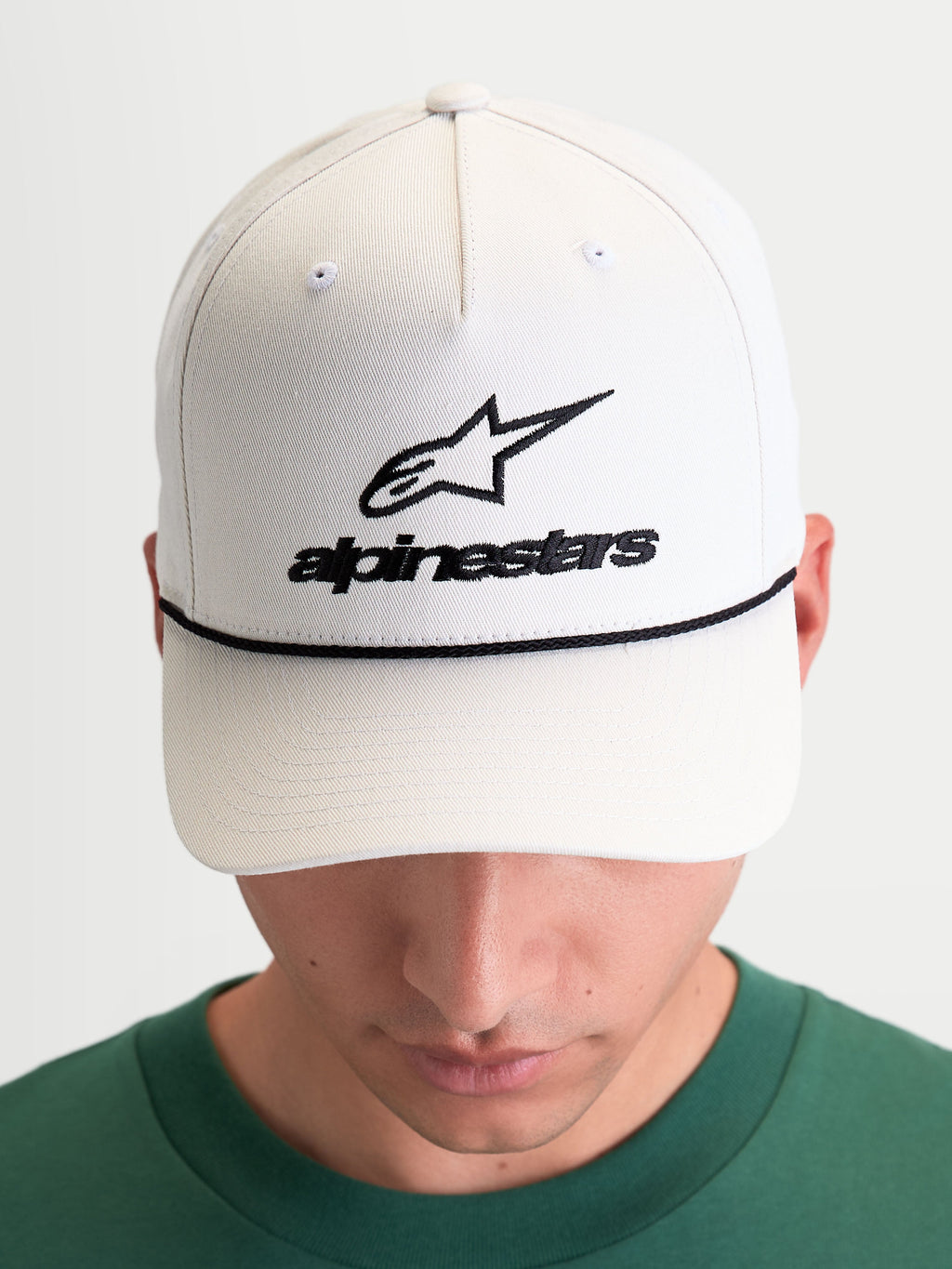 Alpinestars Combo Logo Snapback Hat, Sportswear Lifestyle Cap, Unisex, Off-White and Black, featuring a curved bill, structured crown, front embroidered Astars logo, and decorative black rope detailing, 100% cotton twill.