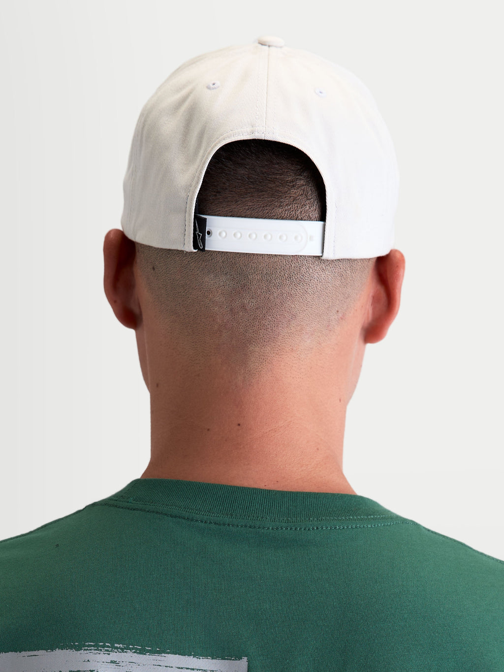 Alpinestars Combo Logo Snapback Hat, Off White Motorsport Sportswear Cap, Rear View on model, showing the adjustable snapback closure and branded back label, durable 100% cotton twill construction.