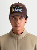 Alpinestars Hemmings Trucker Hat, Casual Sportswear Cap, Unisex, Brown, Twill Front and Mesh Back with Alpinestars 'Racing Ahead' Woven Logo Patch, Curved Bill, On-Model Front View