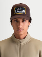 Alpinestars Hemmings Trucker Hat, Casual Sportswear Cap, Unisex, Brown, Twill Front and Mesh Back with Alpinestars 'Racing Ahead' Woven Logo Patch, Curved Bill, On-Model Front View