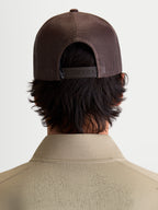 Alpinestars Hemmings Trucker Hat, Brown Sportswear Snapback Cap, Back View on Model showing Breathable Poly Mesh Panels and Adjustable Snap Closure for Casual Everyday Wear