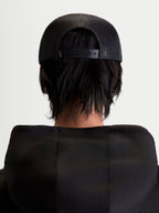 Alpinestars Gravel Trucker Hat, Sportswear Snapback Cap, Unisex, Black, Rear View on Model showing the Breathable Poly Mesh Back and Adjustable Snapback Closure.