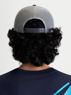 Alpinestars Gravel Trucker Hat, Gray and Black Sportswear Trucker Cap, rear view on model showing the breathable poly mesh back and adjustable snapback closure for a personalized fit.
