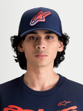 Alpinestars Meteorite Trucker Hat, Sportswear Mesh Back Cap for Men and Women, Navy Blue with Red and White Astars Gravel Texture Logo, Structured Crown, Curved Bill, Front View on Model