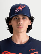 Alpinestars Meteorite Trucker Hat, Sportswear Mesh Back Cap for Men and Women, Navy Blue with Red and White Astars Gravel Texture Logo, Structured Crown, Curved Bill, Front View on Model