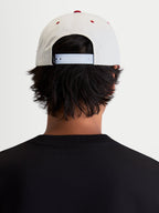Alpinestars Stadium Snapback Hat, Sportswear Casual Cap, Off White and Red, featuring an adjustable snapback closure and structured crown, back view on-model showing the fit for everyday motorsport-inspired lifestyle.