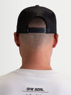 Alpinestars Hotlink Trucker Hat, Sportswear Lifestyle Cap, Unisex, Brown and Black, Rear view on-model showing adjustable snapback closure, mesh back panels for breathability, and premium branding detail.