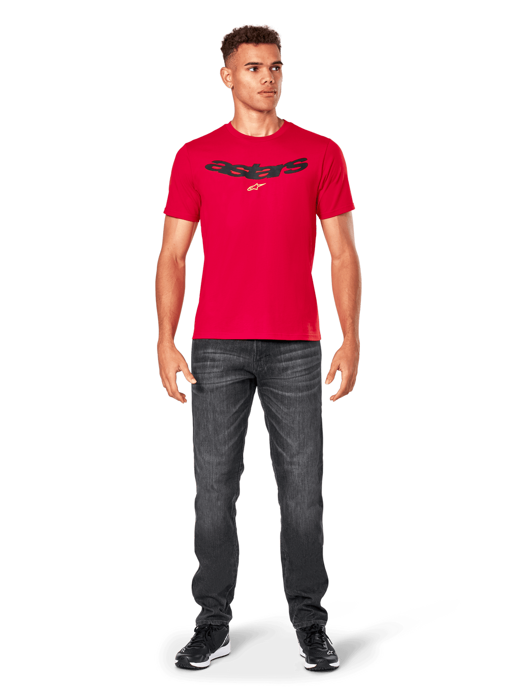 Alpinestars Elliptic CSF Tee, Red Short Sleeve T-Shirt, worn by model with dark gray jeans and black sneakers, black arched Astars logo and yellow star on chest, casual motorsport streetwear