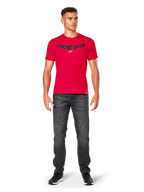 Alpinestars Elliptic CSF Tee, Red Short Sleeve T-Shirt, worn by model with dark gray jeans and black sneakers, black arched Astars logo and yellow star on chest, casual motorsport streetwear