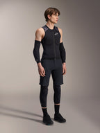 Alpinestars A-Motion Plasma Protection Vest, Sleeveless Black and Camo MTB Protection Vest, full body view of model wearing vest with arm sleeves and knee pads, zippered front with white Alpinestars logo, high-performance gear for mountain biking