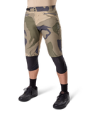 Alpinestars A-Dura Camo Liner Short, Mountain Bike Shorts, Brown Camo pattern, front view showing zippered pockets and side waist adjusters, worn with black knee pads and black cycling shoes, durable gear for MTB