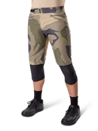 Alpinestars A-Dura Camo Liner Short, Mountain Bike Shorts, Brown Camo pattern, front view showing zippered pockets and side waist adjusters, worn with black knee pads and black cycling shoes, durable gear for MTB