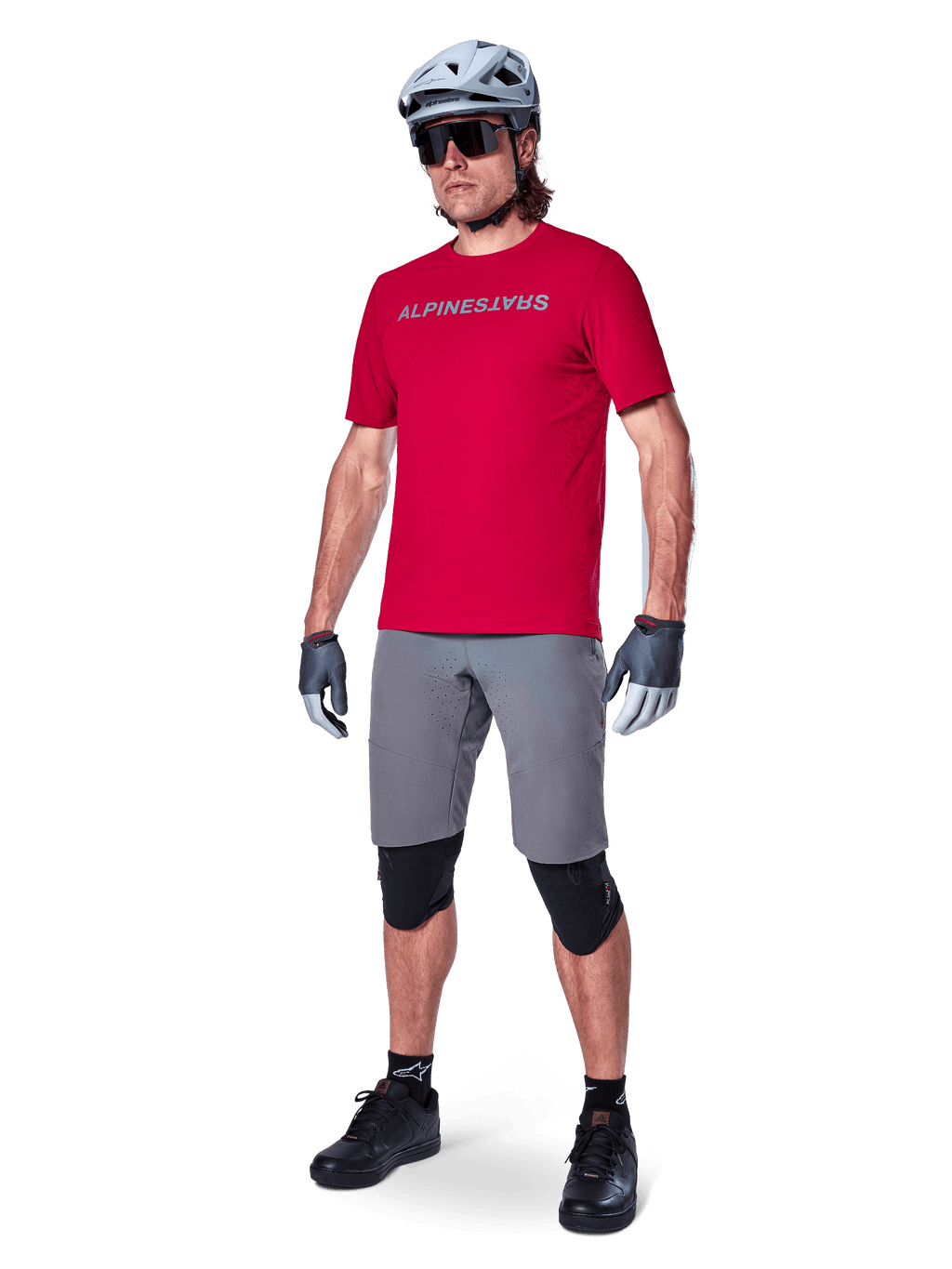 Alpinestars A-Aria Elite Shorts, Men's Dark Gray MTB shorts with 4-way stretch fabric, on model with red cycling gear.