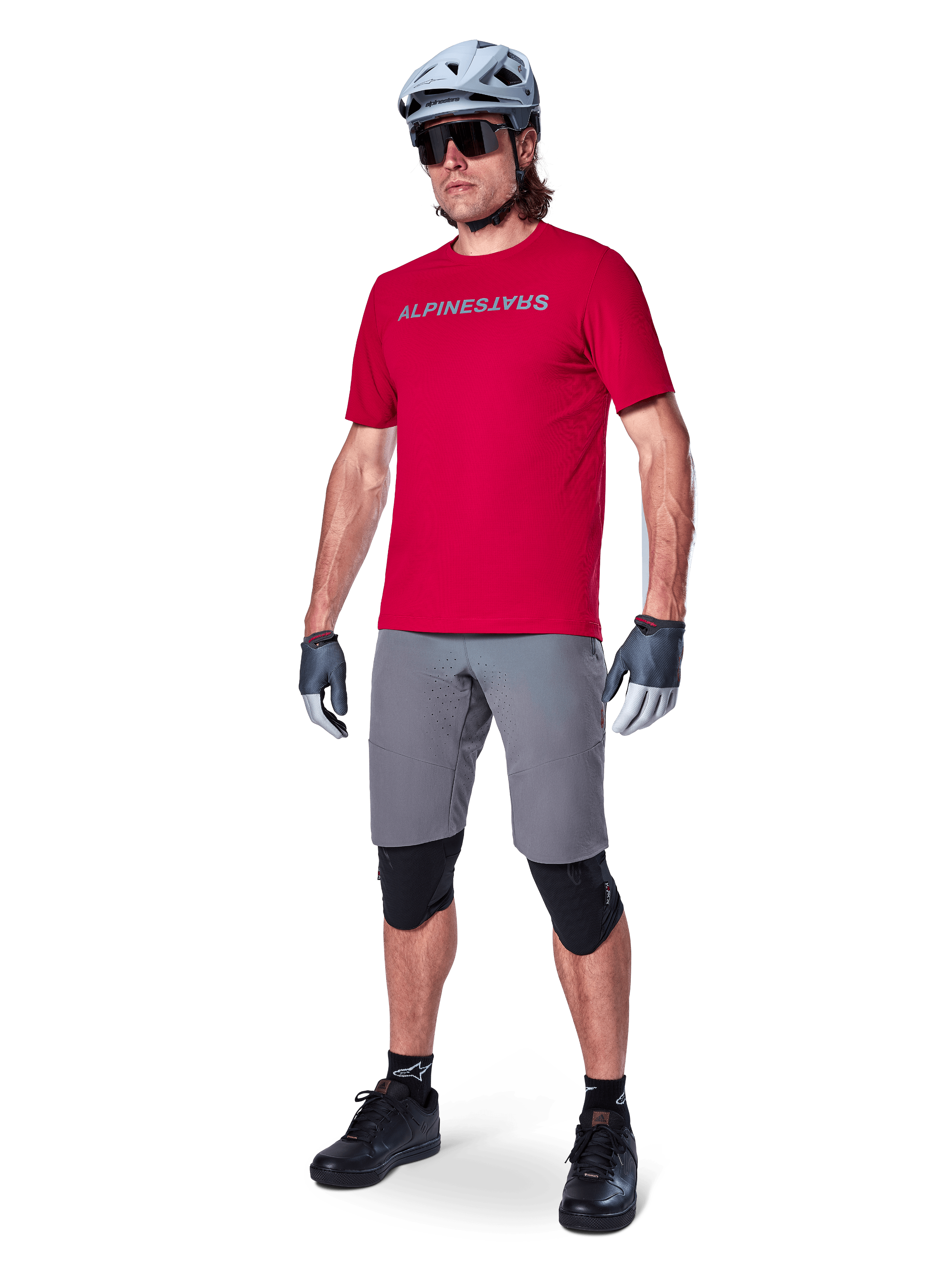 Alpinestars A-Aria Elite Shorts, Men's Dark Gray MTB shorts with 4-way stretch fabric, on model with red cycling gear.