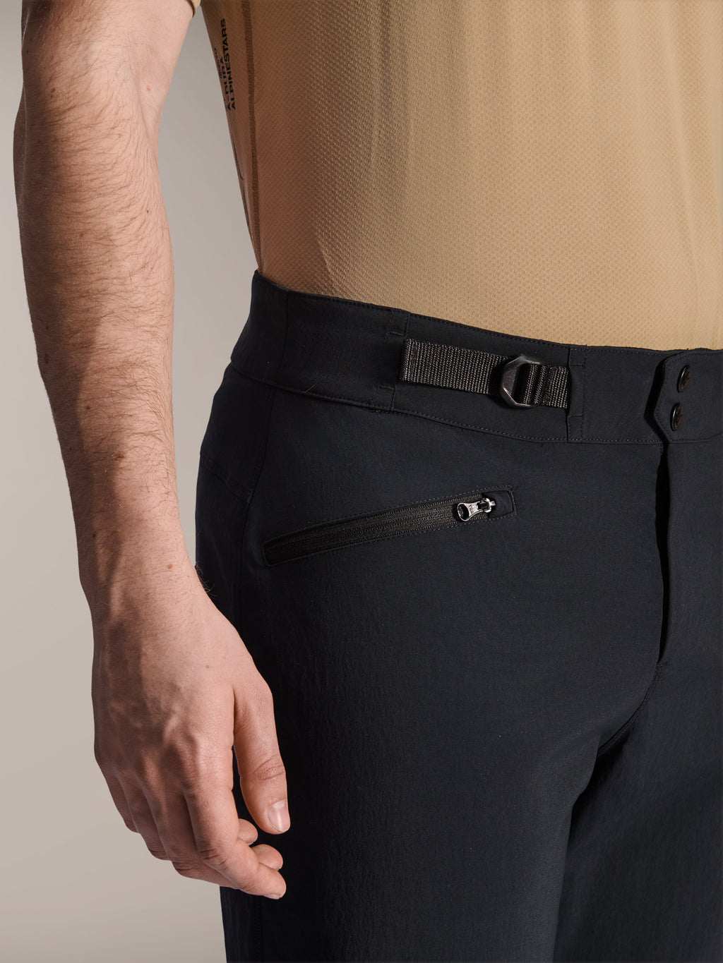 Alpinestars A-Dura Shorts, Black MTB shorts, close-up view showing zippered pocket and adjustable side cinch strap, double snap closure, durable fabric for mountain biking