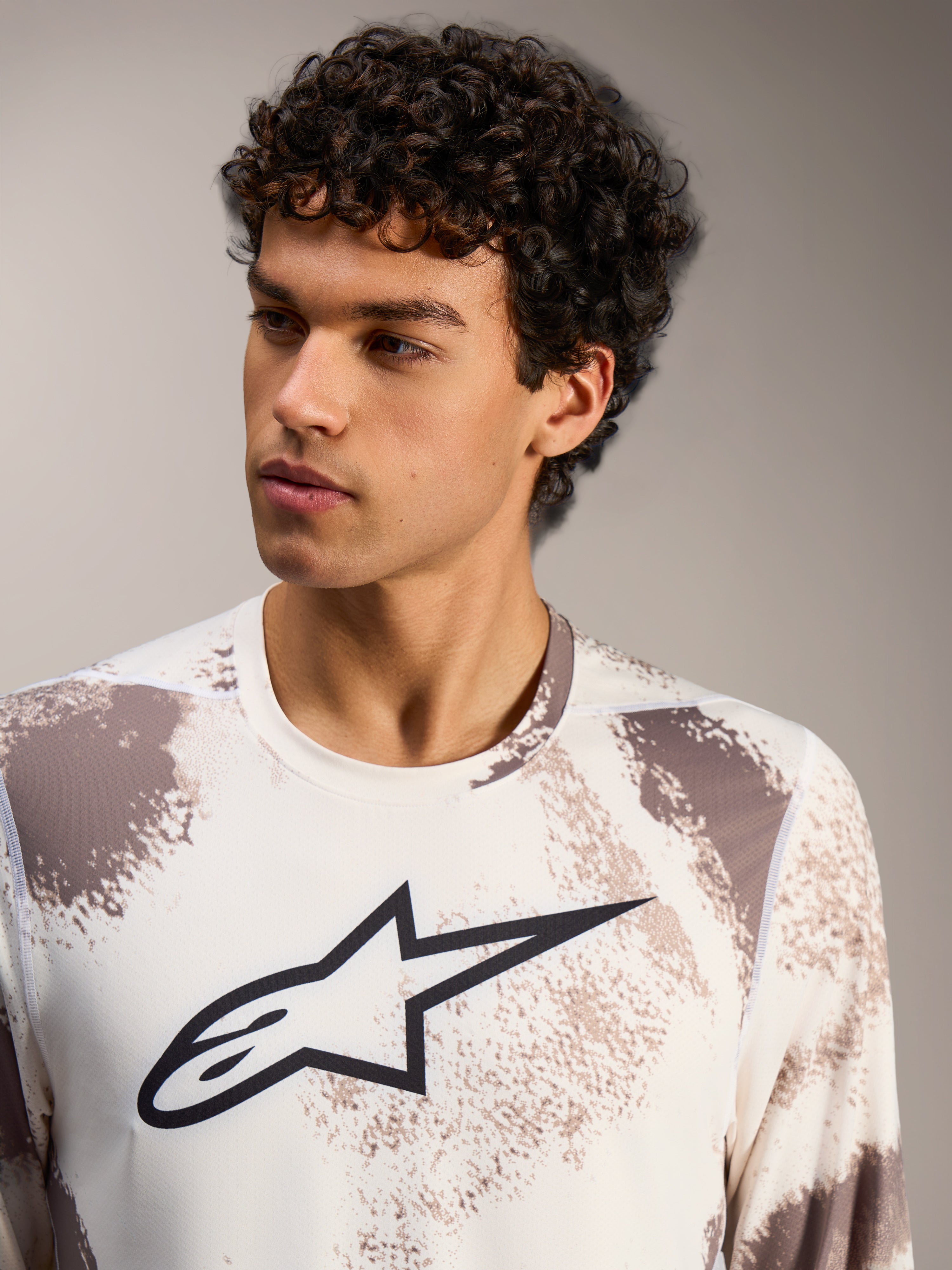 Alpinestars A-Dura Ride Long Sleeve Jersey in Sand Camo, a performance MTB top featuring a bold black chest logo.