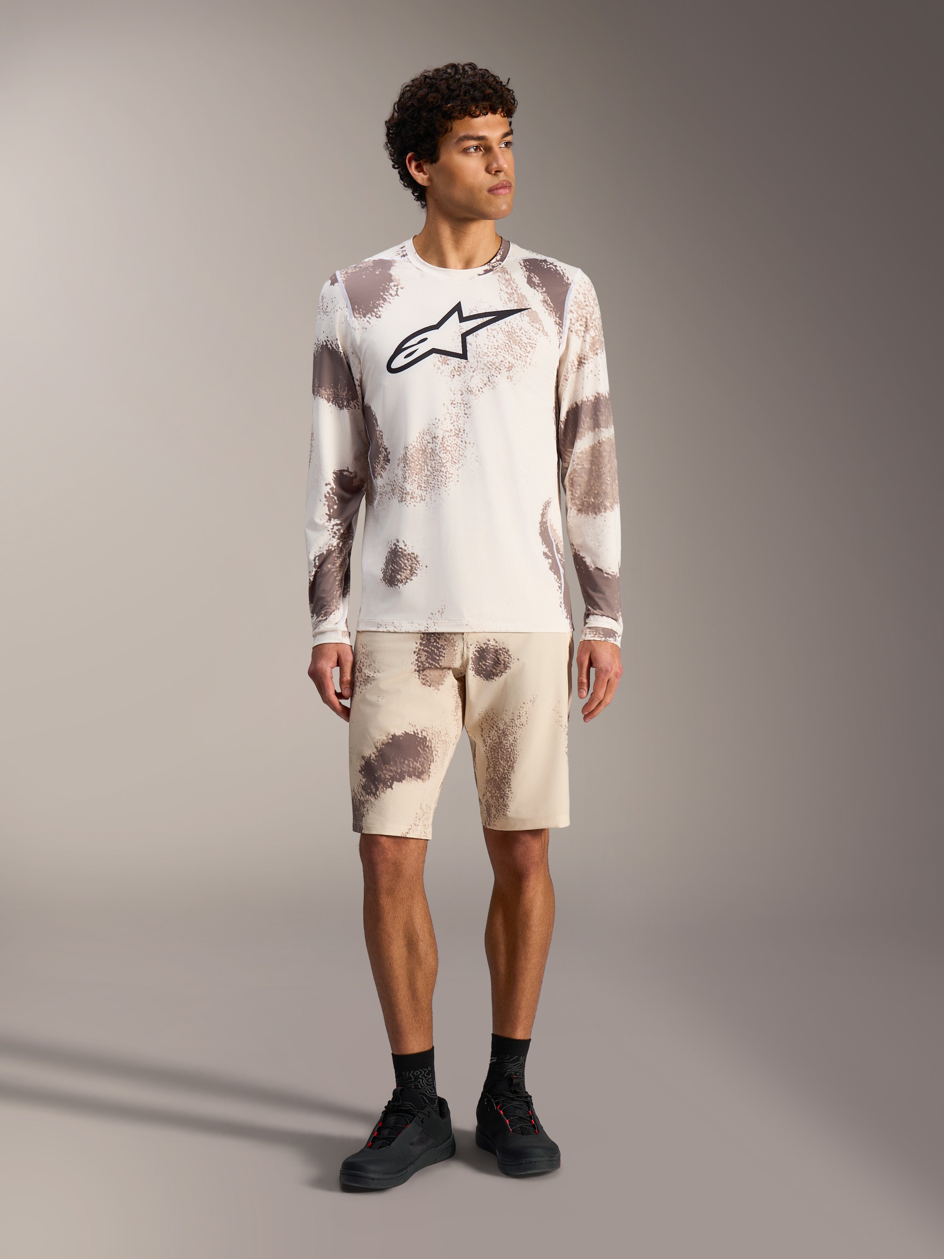 A-Dura Ride Long Sleeve Jersey in sand camo, performance MTB apparel featuring a large black Astars logo on the chest.