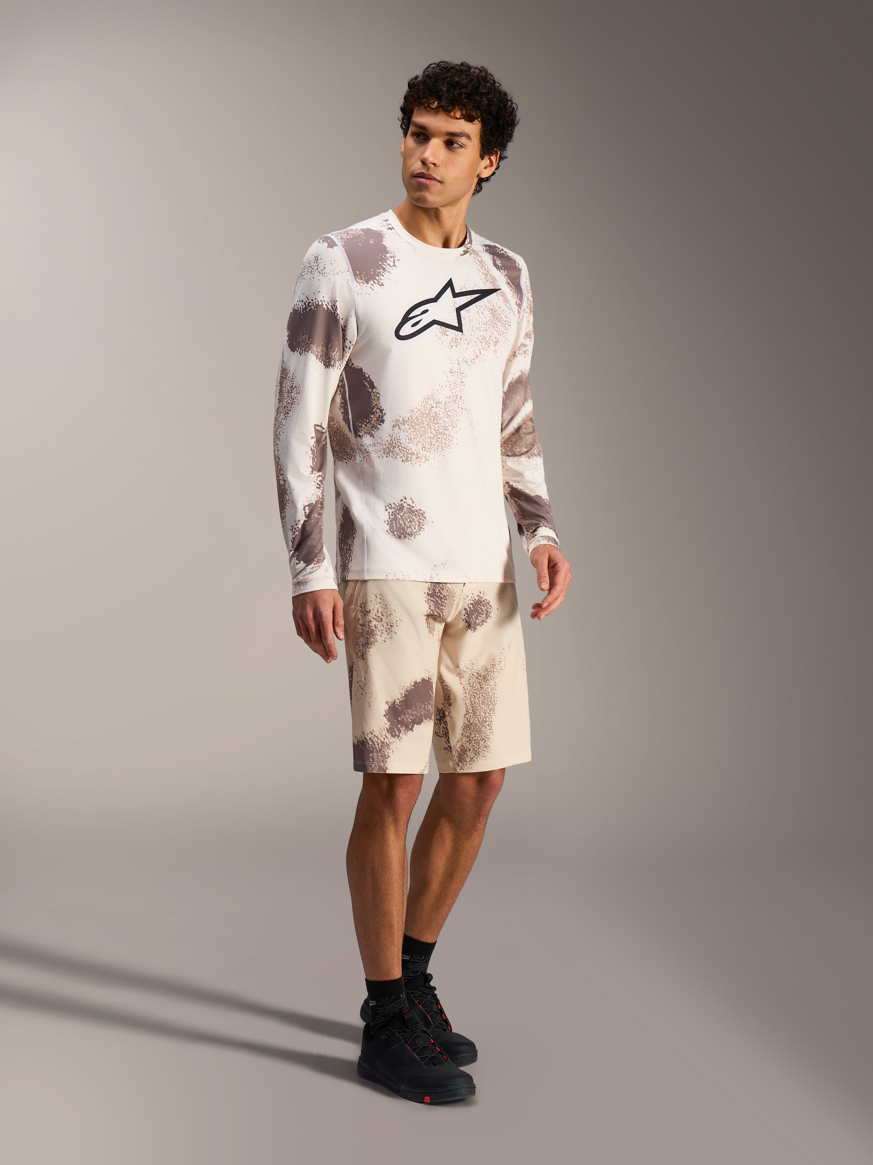 A-Dura Ride Long Sleeve Jersey in Sand Camo, performance MTB gear with bold chest logo and matching patterned shorts.