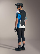 Alpinestars A-Dura Race SS Jersey in blue and black with black MTB shorts, helmet, and protective mountain bike gear.