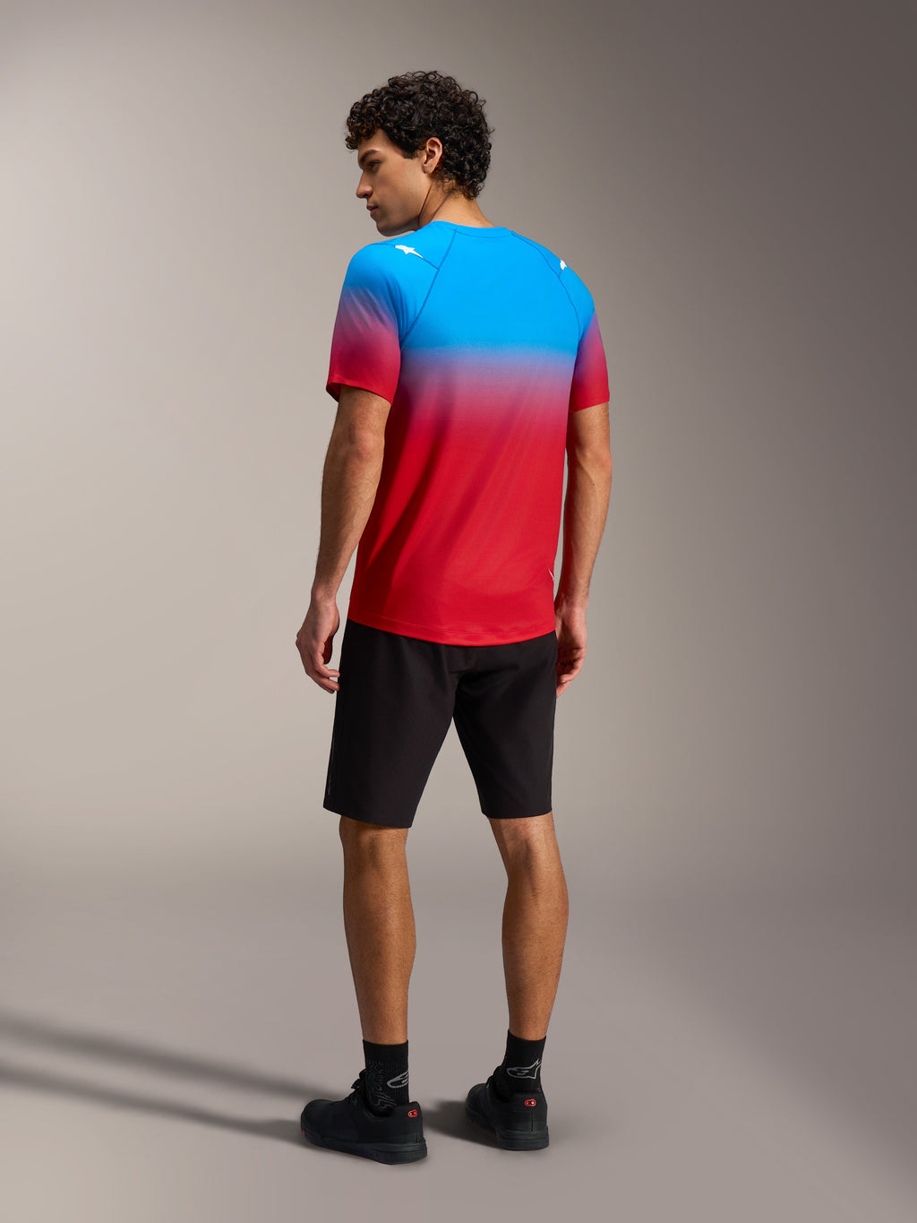 A-Dura ASTARS 2.0 Short Sleeve Jersey, Bright Red Blue gradient, back view on model, performance mountain bike gear.