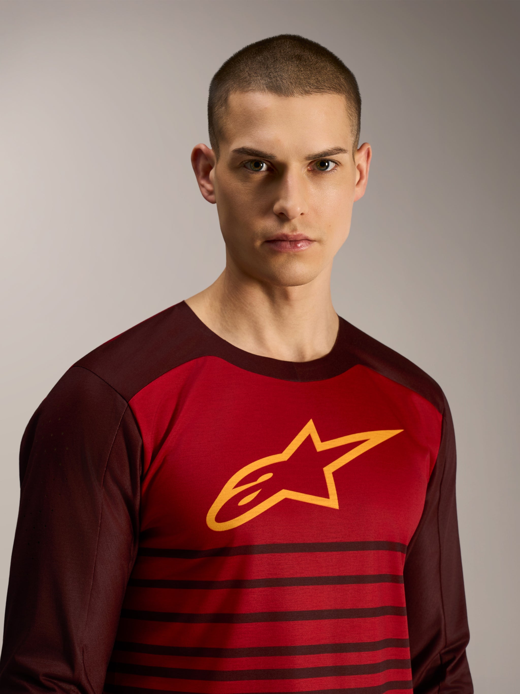 A-Dura Elite Long Sleeve Jersey in Bordeaux, featuring a yellow star logo and striped pattern for MTB performance.