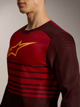 A-Dura Elite Jersey 2.0 in Bordeaux red with long sleeves, featuring a yellow chest logo and laser-cut bicep perforations.