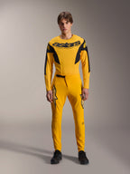 Limited Edition A-Supra Melt Gold Gear Set, Alpinestars Mountain Bike Apparel, Dark Yellow and Black, Model wearing long-sleeve jersey with bold 'astars' chest logo and matching performance pants, featuring laser-cut ventilation on inner thighs and a secure ratchet waist closure, professional MTB racing kit