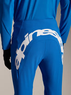 Alpinestars A-Supra Melt Pants and Jersey, Blue MTB gear, rear view featuring large white Alpinestars wordmark on the back yoke of the pants, matching long-sleeve jersey and black gloves
