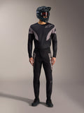 Black A-Supra Elite MTB kit featuring a long-sleeve jersey and racing pants with grey logos and a full-face helmet.